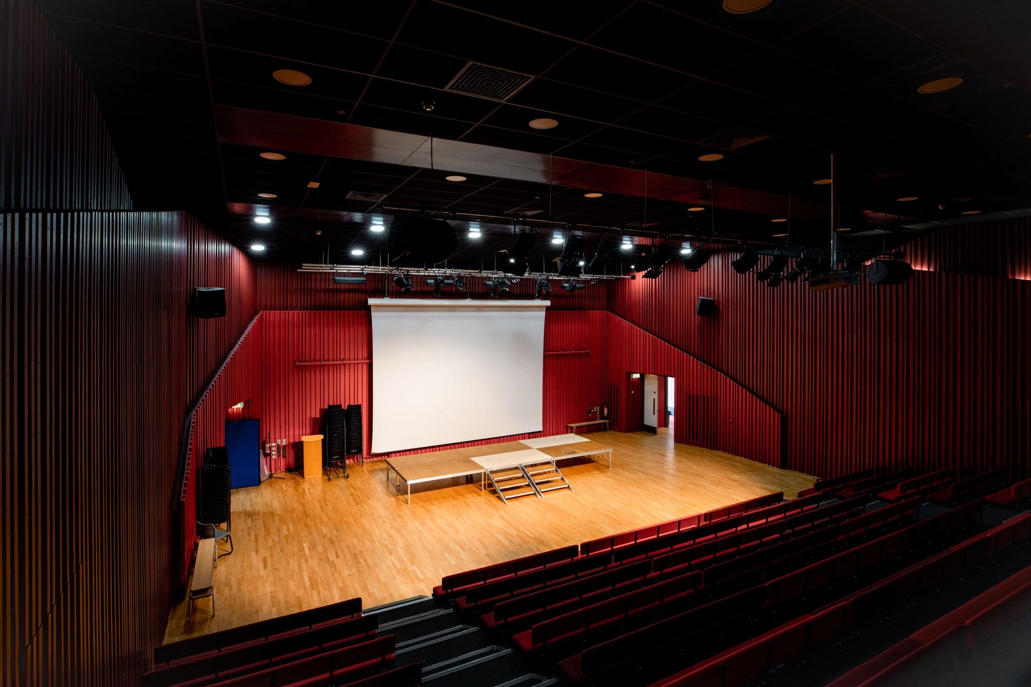 Stage lights shining across a theatre stage